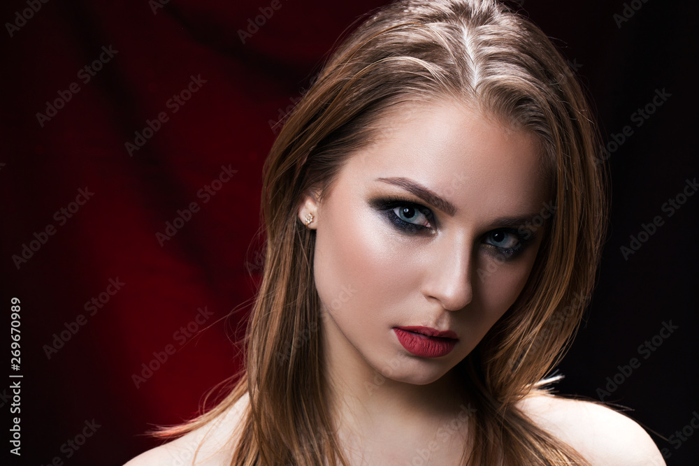Fototapeta premium Beauty portrait of a beautiful brunette on black background