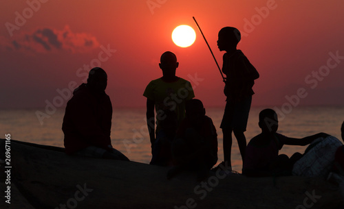 Silhouettes of fishermen at sunrise Chitimba, Lake Malawi, Malawi. 
