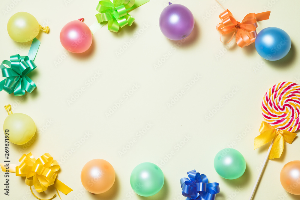 Happy holiday frame background with colorful balloon, gifts, confetti, carnival cap and streamer. Flat lay. Top view. Birthday or party card with copy space. Happy holiday frame background with colorful balloon, gifts, confetti, carnival cap and streamer. Flat lay. Top view. Birthday or party card with copy space.