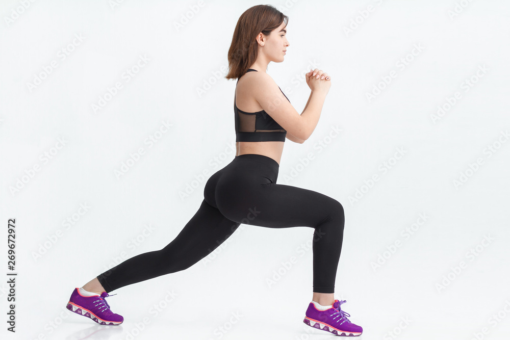 Young brunette woman exercising for weight loss in a gym. Young brunette woman exercising for weight loss in a gym.
