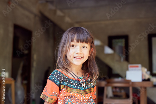 Wallpaper Mural Authentic  portrait of pretty thai baby girl posing outdoors, dressed in traditional colorful dress, jewelry, being in good mood,smiling and looking at camera. Attractive child enjoying life Torontodigital.ca