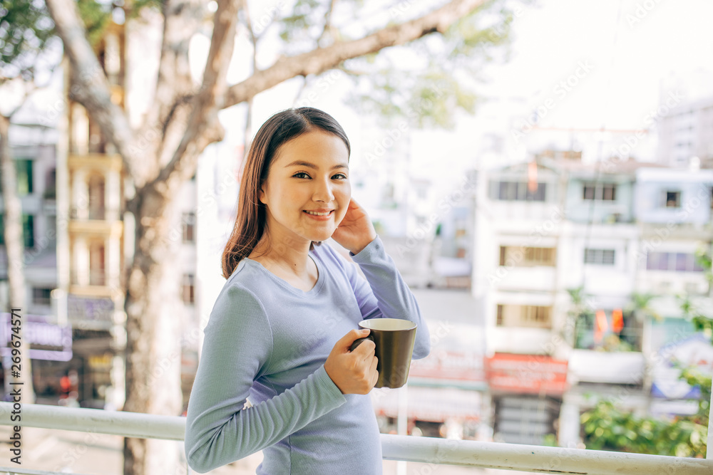 Woman enjoy her coffee at the balcony