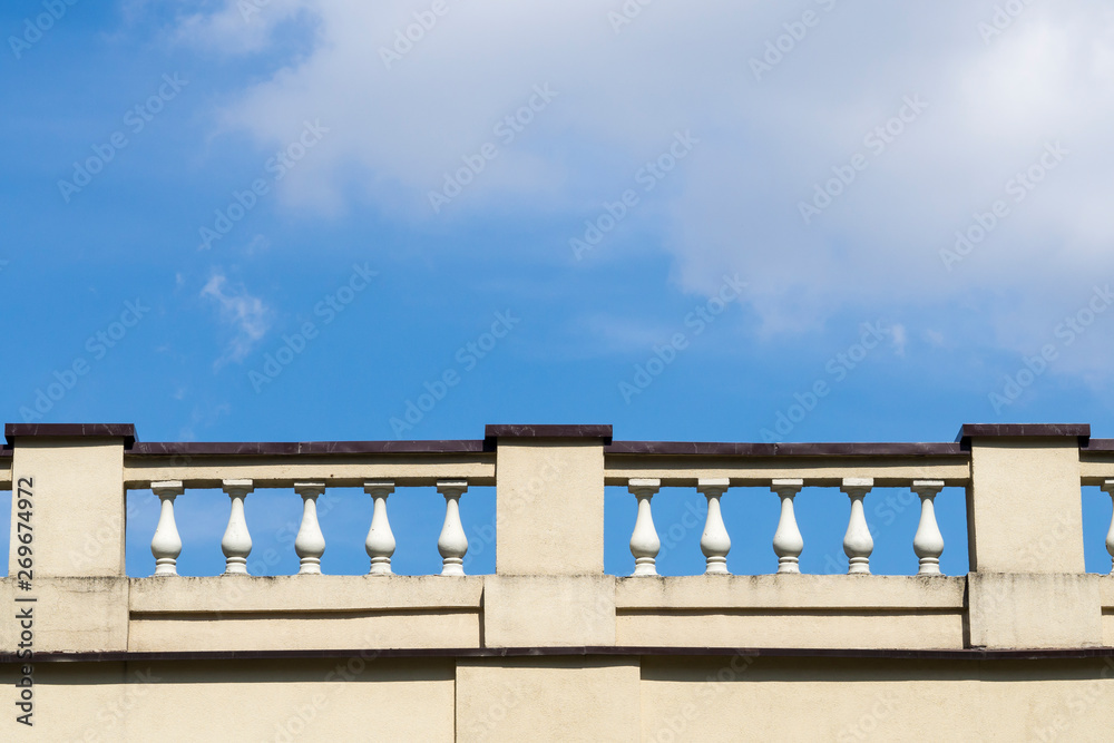 Architectural fence in the form of balusters against the blue sky Architectural fence in the form of balusters against the blue sky