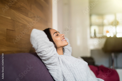 Young relaxed smiling young woman lying on couch photo