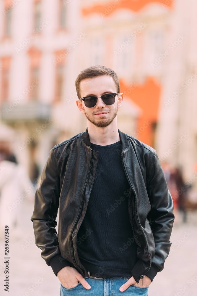 Portrait of stylish handsome young bearded man wears sunglasses Portrait of stylish handsome young bearded man wears sunglasses