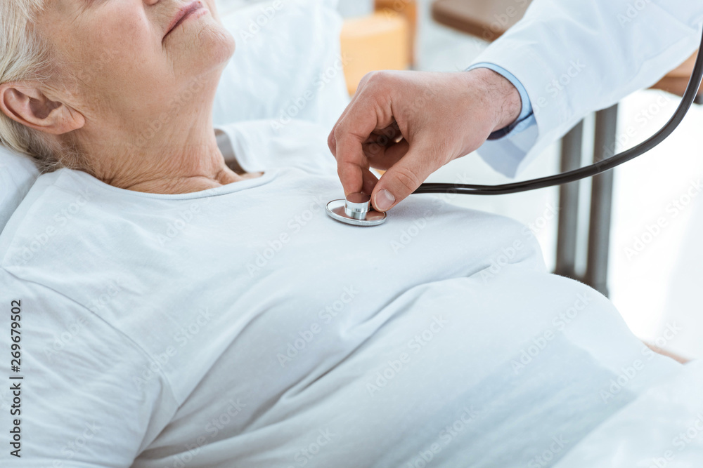 Fototapeta premium partial view of doctor examining sick patient in hospital