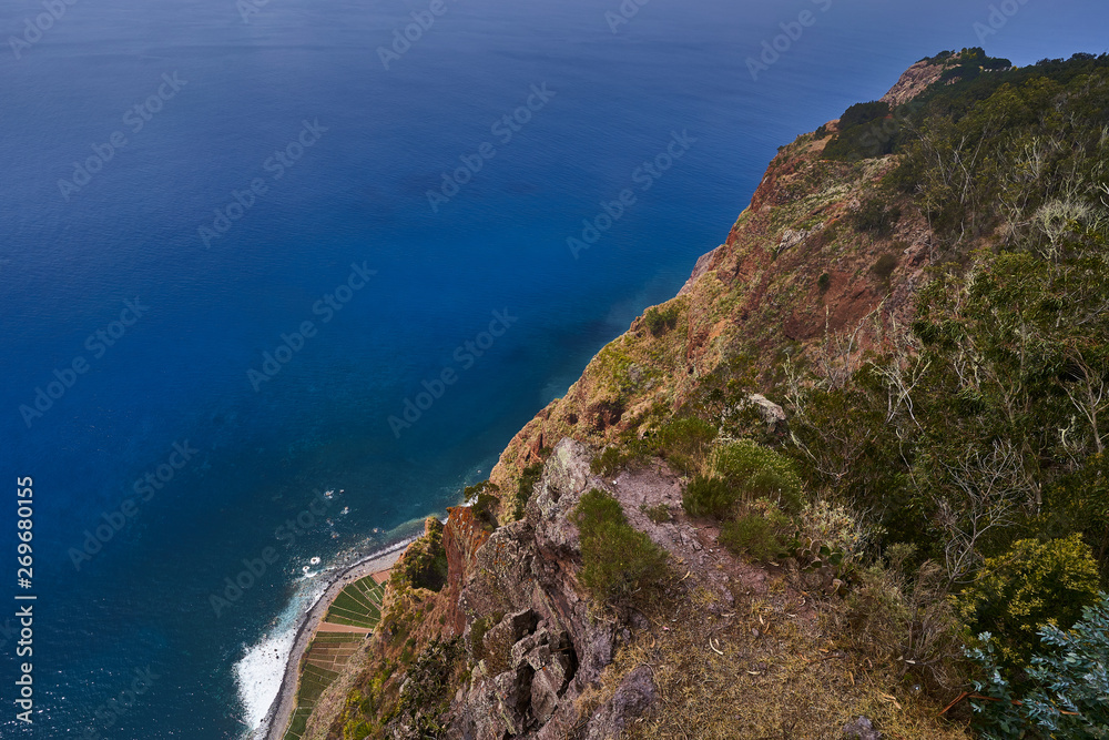 Top view from Cabo Girão Skywalk in Madeira island with blue ocean in background
