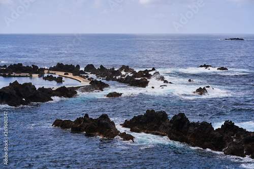 Blue ocean and rocks on a rainy day in Madeira, Porto Moniz, Portugal   © Andrei