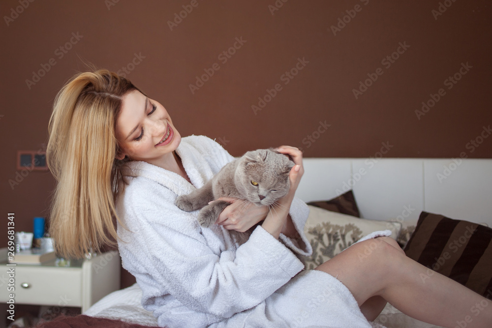 young woman at home playing with a cat. Home interior young woman at home playing with a cat. Home interior
