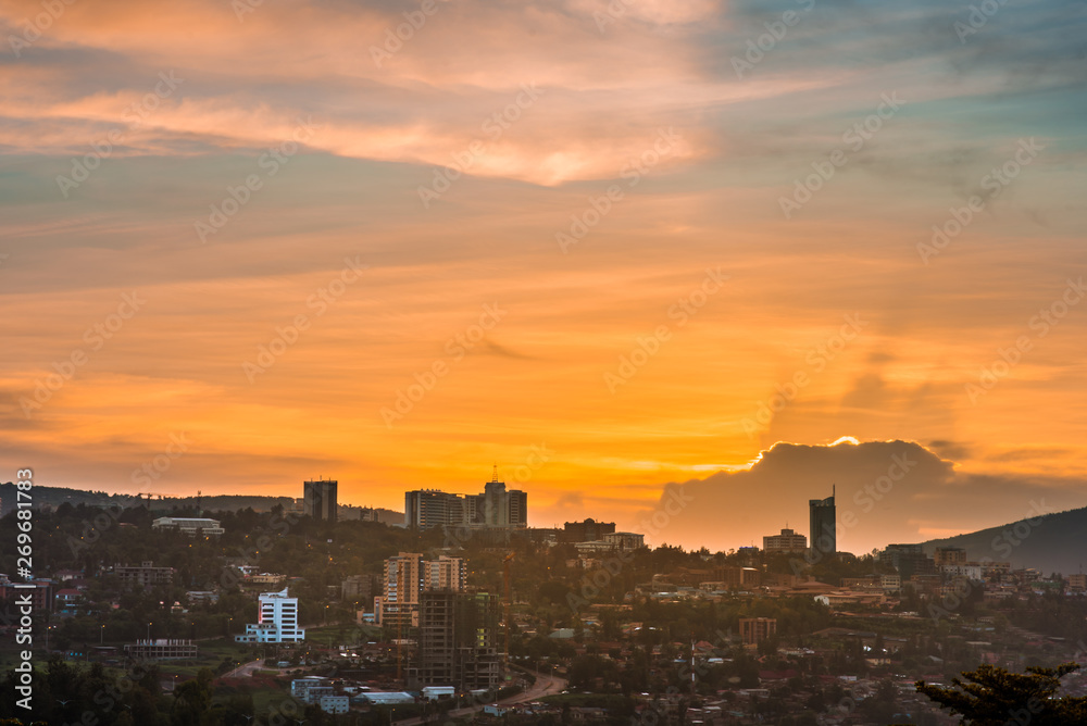 Kigali city centre skyline and surrounding areas under colorful clouds at sunset. Rwanda