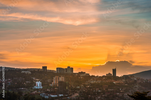 Kigali city centre skyline and surrounding areas under colorful clouds at sunset. Rwanda photo