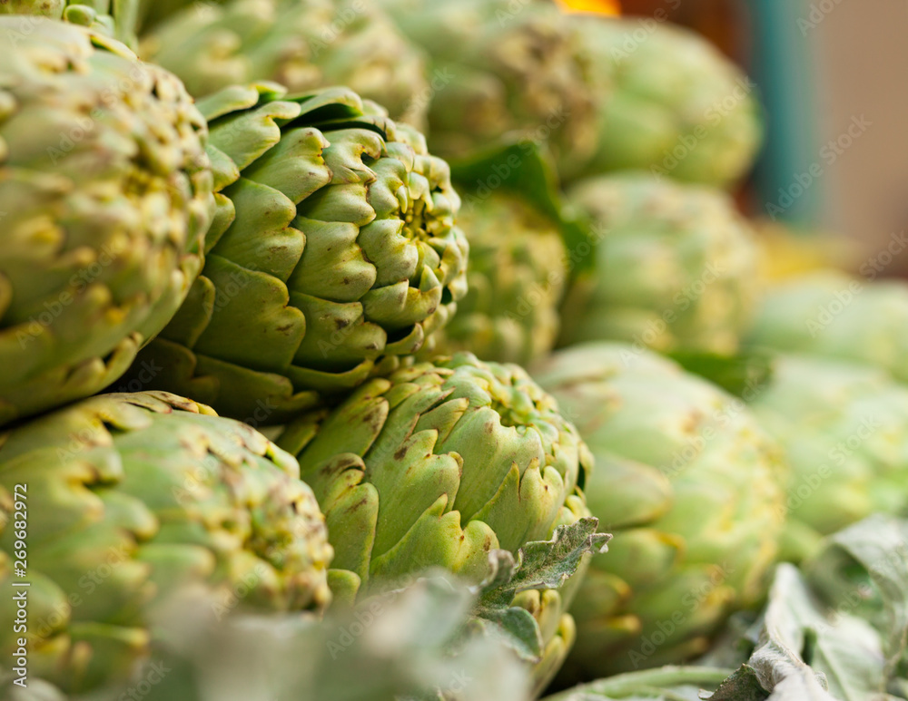 Fresh artichokes on market counter Fresh artichokes on market counter