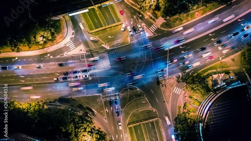 Aerial overhead hyperlapse of traffic at a busy intersection at night photo