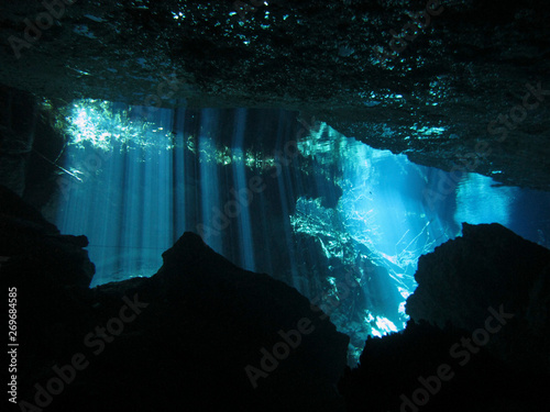 Sun rays entering the water - Underwater at cenote Chac Mool in the Riviera Maya, Mexico. photo