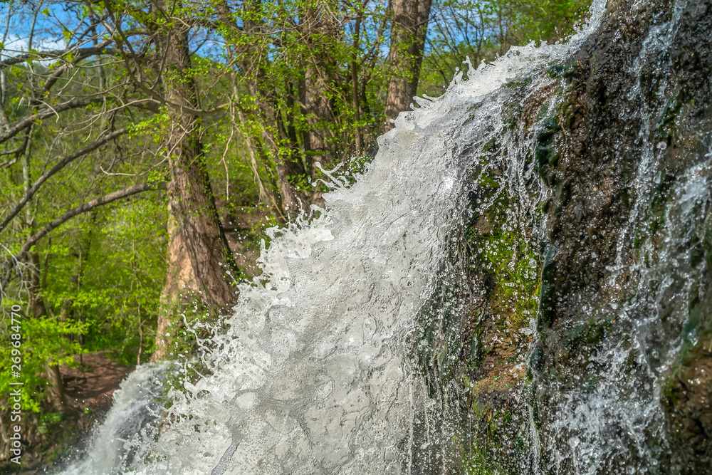 Naklejka premium Mountain river waterfall landscape. View from bottom of Dzhurynskyi waterfall stream. Nyrkiv, Ukraine