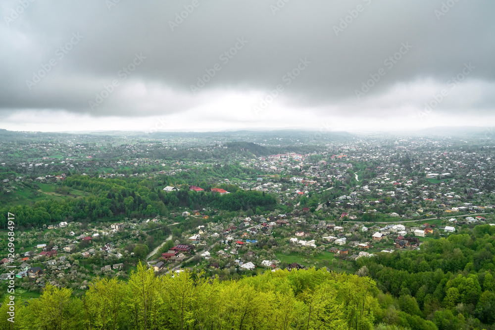 Panoramic view of village in spring mountain forest. Kosiv, Ukraine