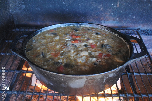 cooking pilaf in cauldron on fire