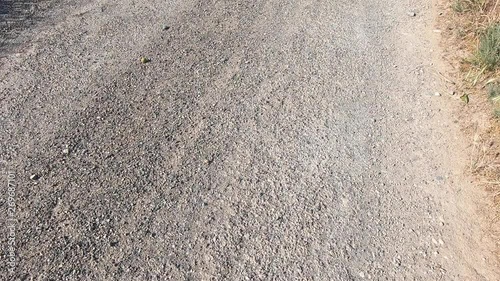 Concrete road and stones through a rural area.