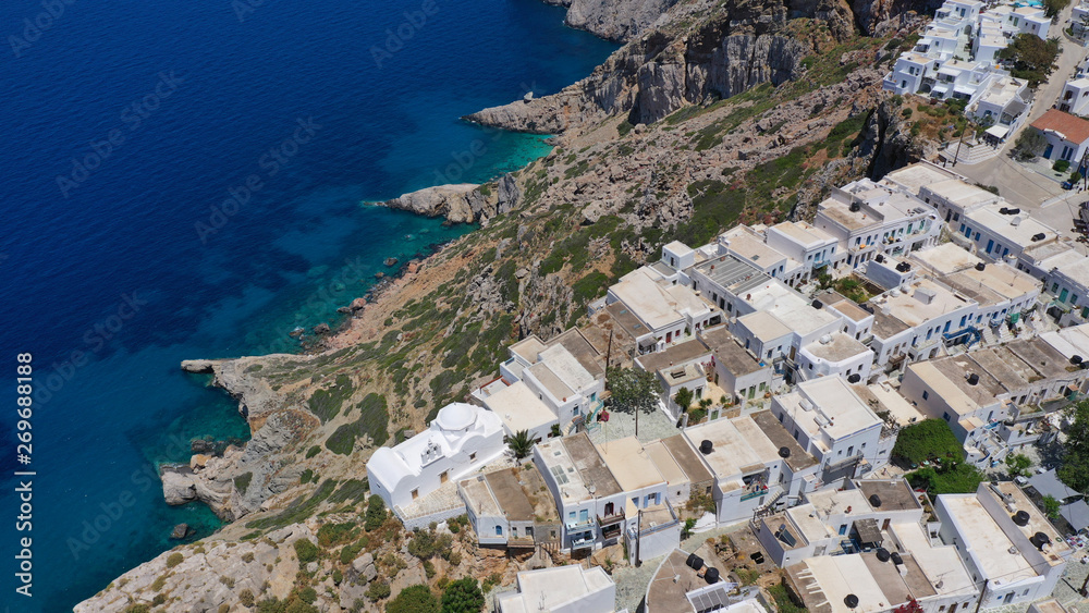 Aerial drone photo of picturesque main village (chora) of Folegandros island featuring uphill church of Panagia (Virgin Mary) built on top of steep hill overlooking the Aegean sea, Cyclades, Greece