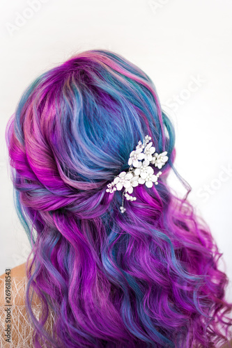 Stylish trendy hairstyle of curly blonde hair. Fashionable hair coloring,