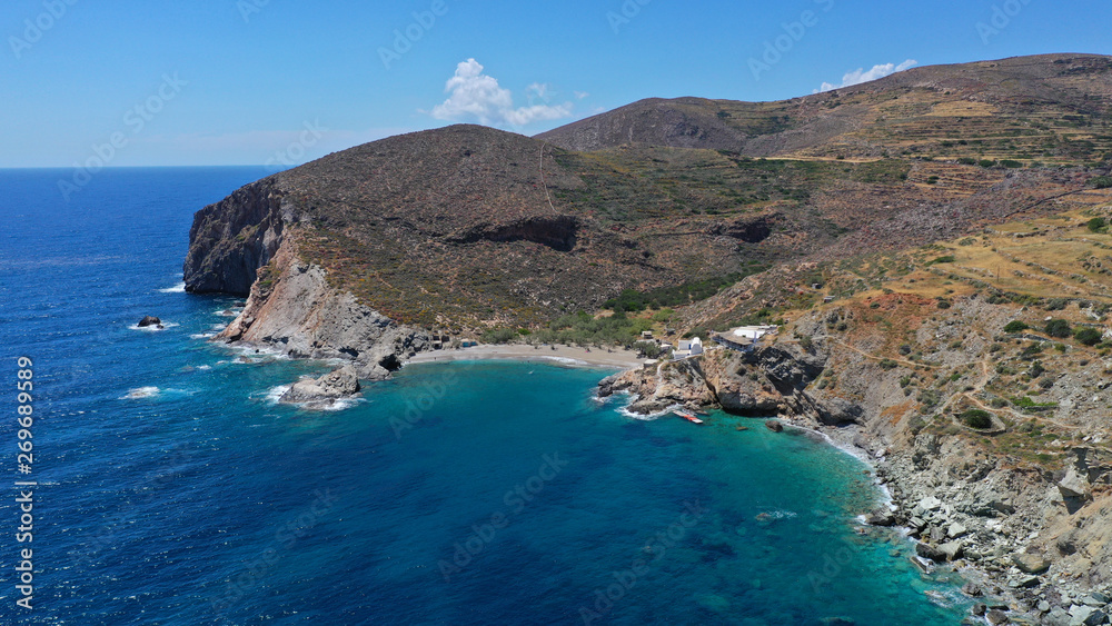 Aerial drone photo of secluded deep turquoise beach of Agios Nikolaos with crystal clear sea and sandy sea shore, Folegandros island, Cyclades, Greece