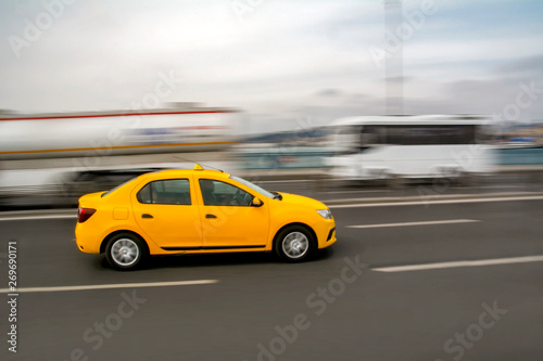Evening traffic long exposure yellow turkish taxi car on istanbul 