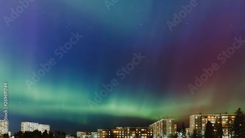 panorama of city at night Northern Lights