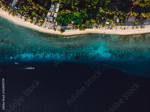 Tropical island with sandy beach and turquoise ocean. Aerial view.