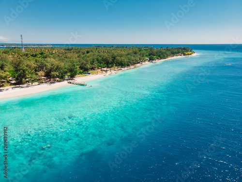 Tropical island with beach and turquoise ocean. Aerial view. © artifirsov