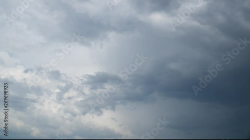 Time lapse. Intensive formation of comulus clouds  in hot day. photo