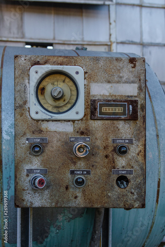Industrial control box with switches and buttons in an abandoned factory