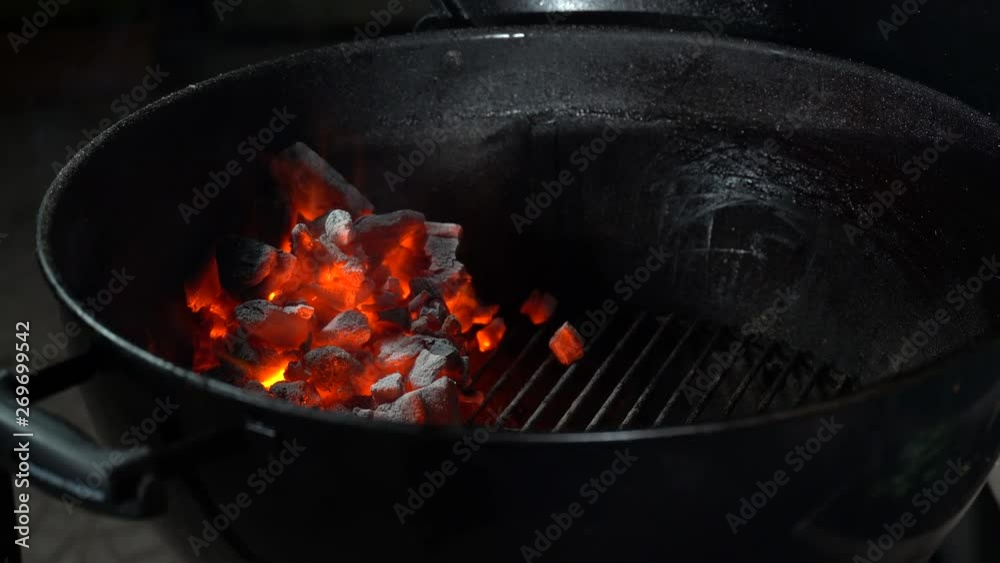 Modern round metal brazier grill and burning coal inside it Modern round metal brazier grill and burning coal inside it