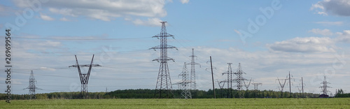 Panorama of high voltage substation. Distribution electrical power. Silhouettes of pylons and towers