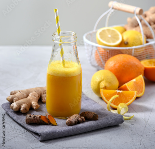 Turmeric or curcuma drink with ginger, healthy detox vitamin orange juice