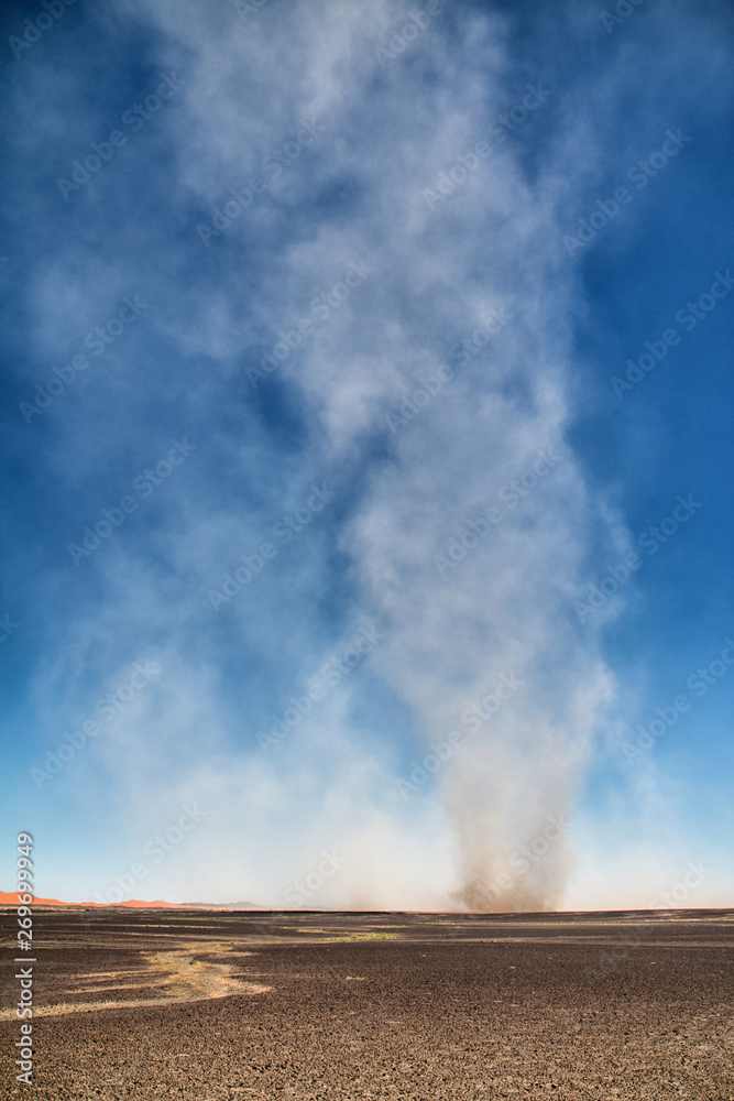 Dust devils over a rocky desert in Merzouga, Morocco