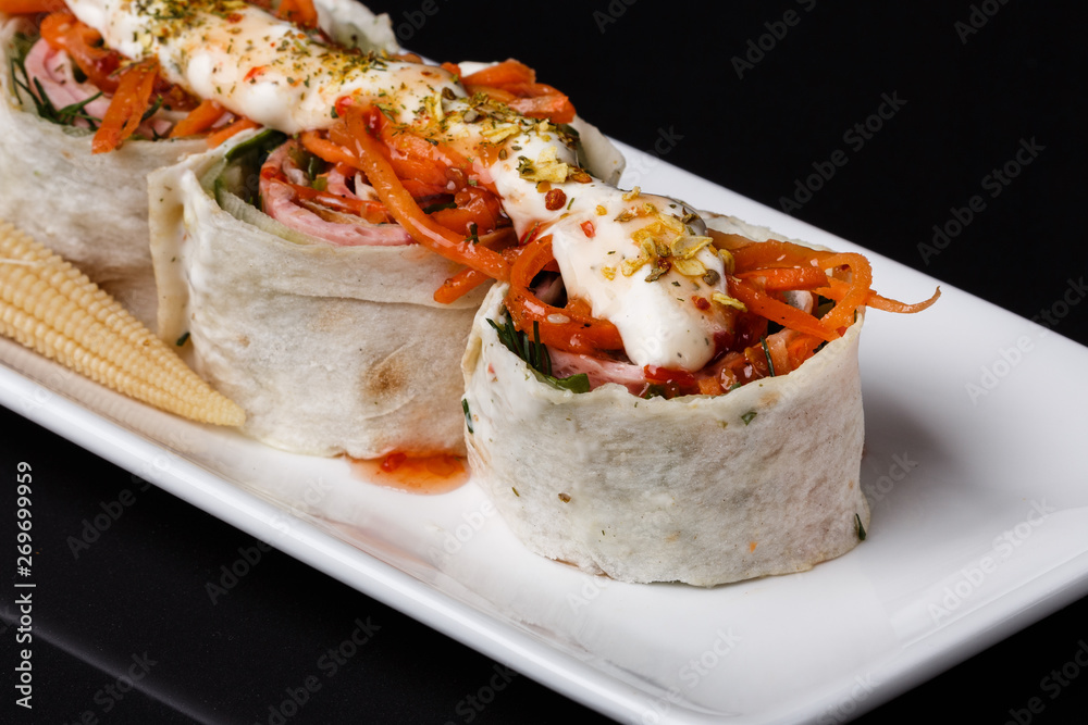 Rolls with pita and ham on white plate Rolls with pita and ham on white plate