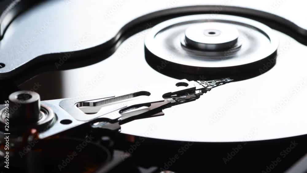 Detail of computer hard disk drive spin up and head movement. Shot in 4K UHD Detail of computer hard disk drive spin up and head movement. Shot in 4K UHD