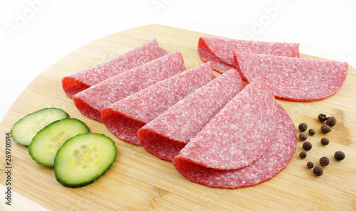slices of salami on wooden board