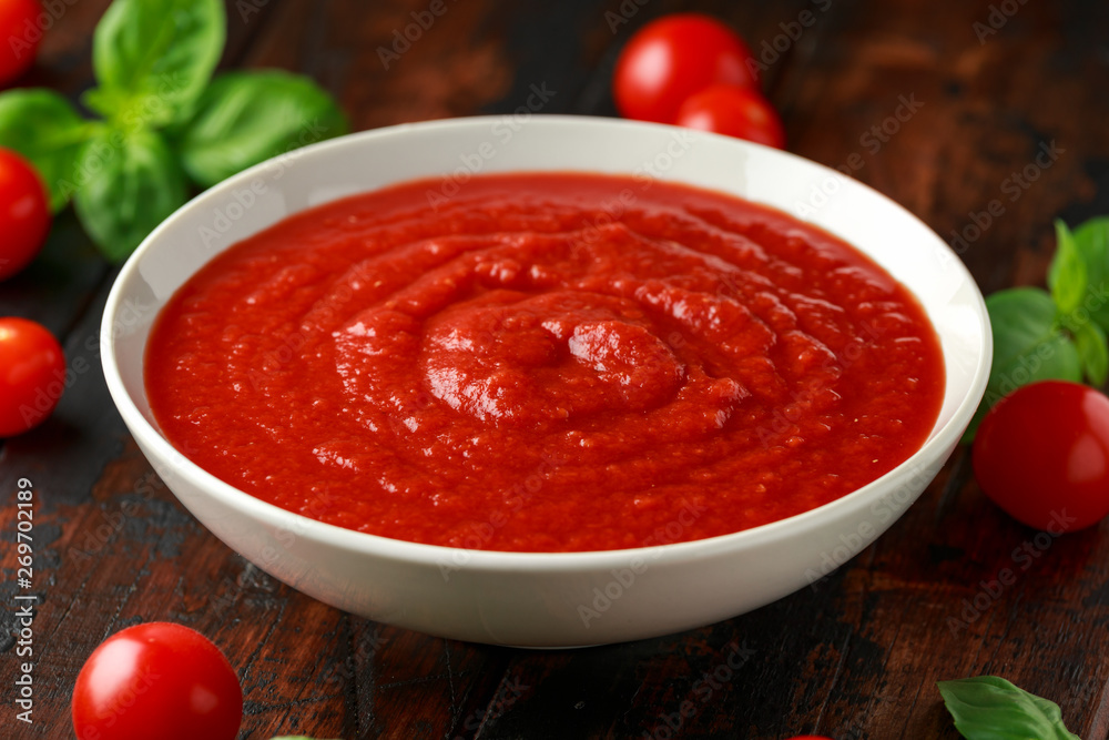 Homemade tomato Passata in white bowl on wooden table Homemade tomato Passata in white bowl on wooden table