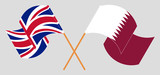 Crossed and waving flags of the UK and Qatar