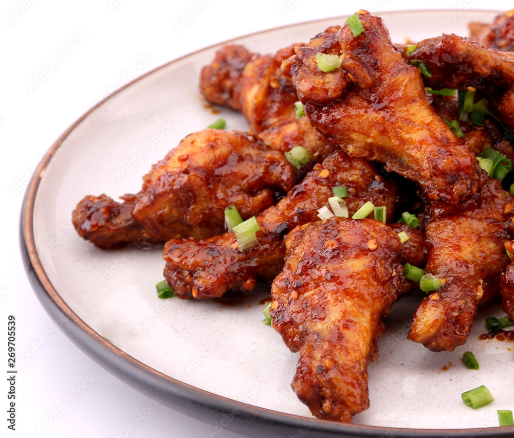 Delicious Korean fried chicken on a white background. Delicious Korean fried chicken on a white background.