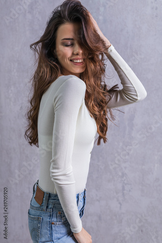 Beautiful young woman in casual clothes  pose in modern interior.