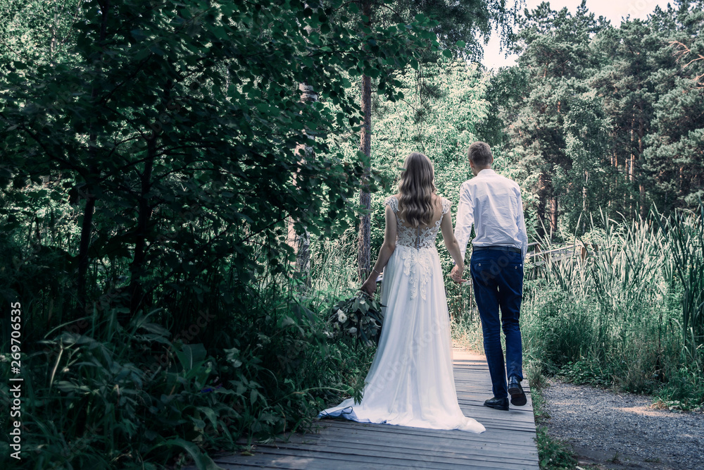 bride and groom walking in the park bride and groom walking in the park