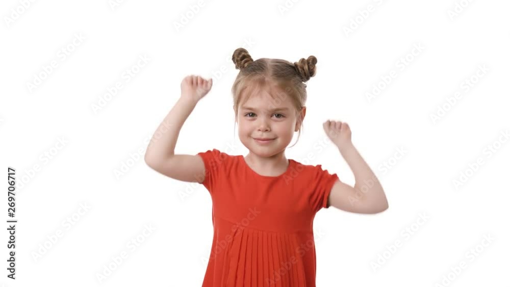 Video portrait of a beautiful happy little girl hands up in red dress isolated on white background. Childhood concept. Studio shot of child emotions in 4K definition. Video portrait of a beautiful happy little girl hands up in red dress isolated on white background. Childhood concept. Studio shot of child emotions in 4K definition.