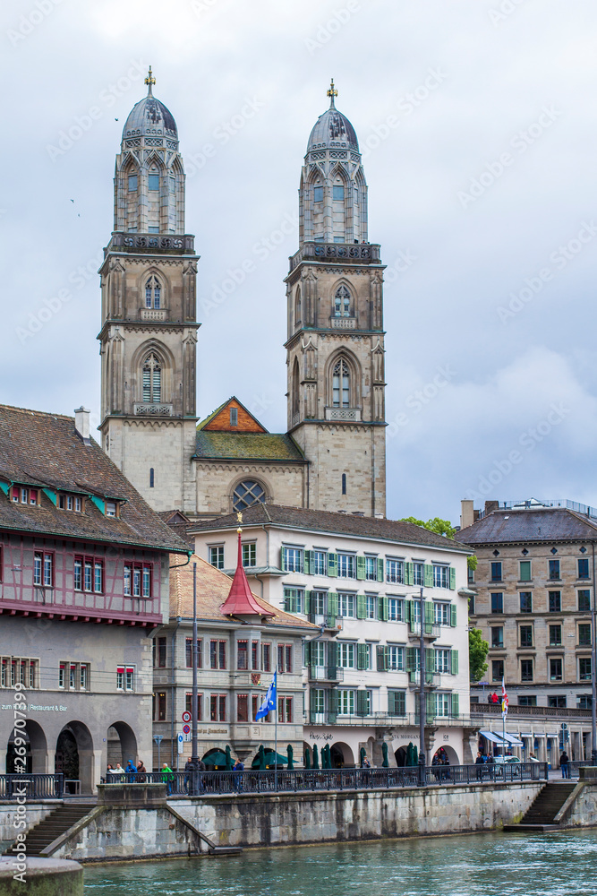 Fototapeta premium Grossmunster. Romanesque Cathedral in Zurich. View of the Grossmunster. Zurich architecture. Lake Zurich. Quay in Zurich