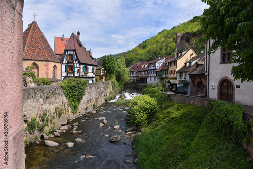 Houses next to La Weiss river in Kayserberg village in Alsace, France