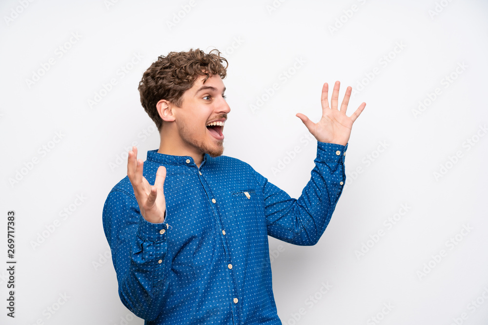 Blonde man with blue shirt with surprise facial expression Blonde man with blue shirt with surprise facial expression