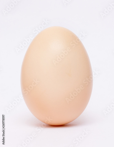 Chicken egg in a vertical position on a white isolated background. Vertical format_