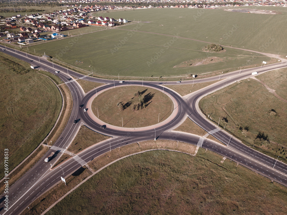 Top down aerial view of a traffic roundabout on a main road Top down aerial view of a traffic roundabout on a main road