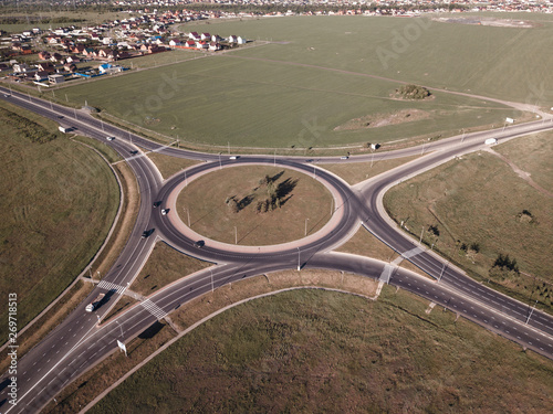 Top down aerial view of a traffic roundabout on a main road © Chepko Danil